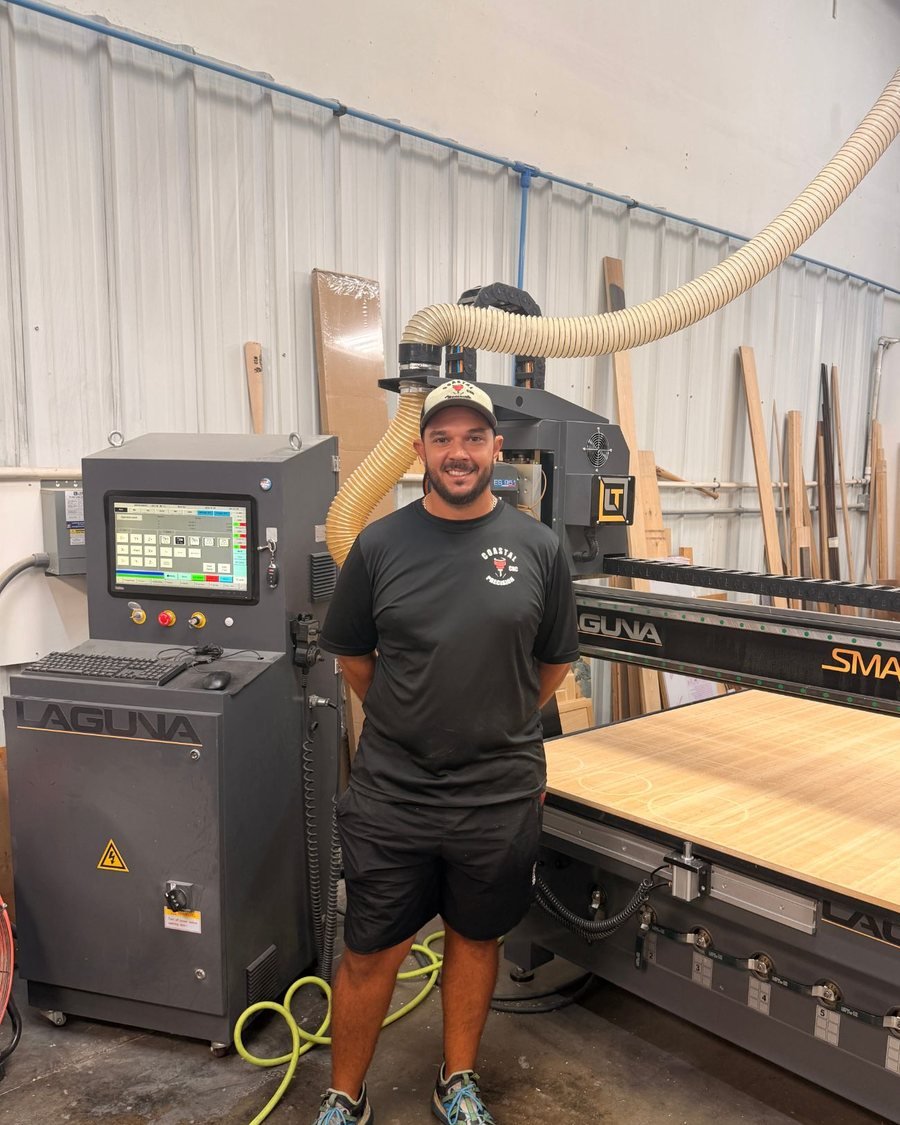 Anthony Troiso, CEO of Coastal Precision CNC, standing at the Laguna CNC router in the Clearwater shop