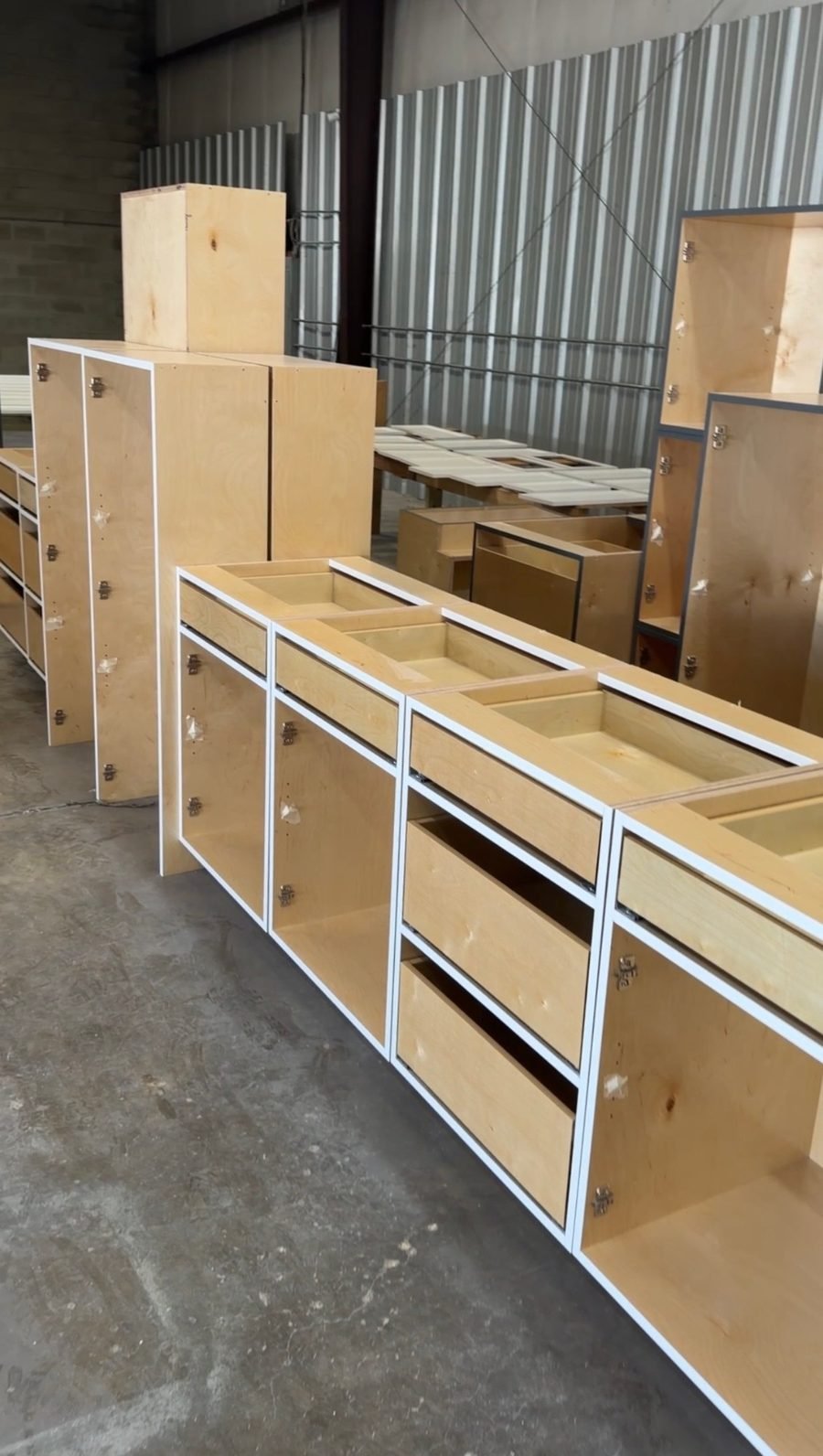 Birch plywood cabinet boxes with soft-close hinges and drawers in the Coastal Precision CNC shop