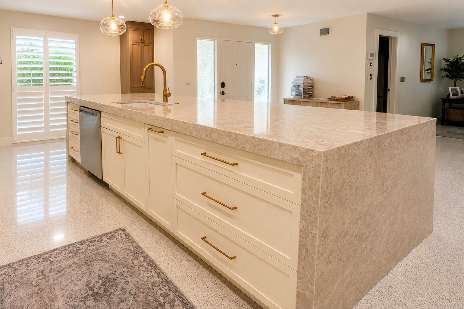 Cream kitchen with waterfall quartz island by Coastal Precision CNC