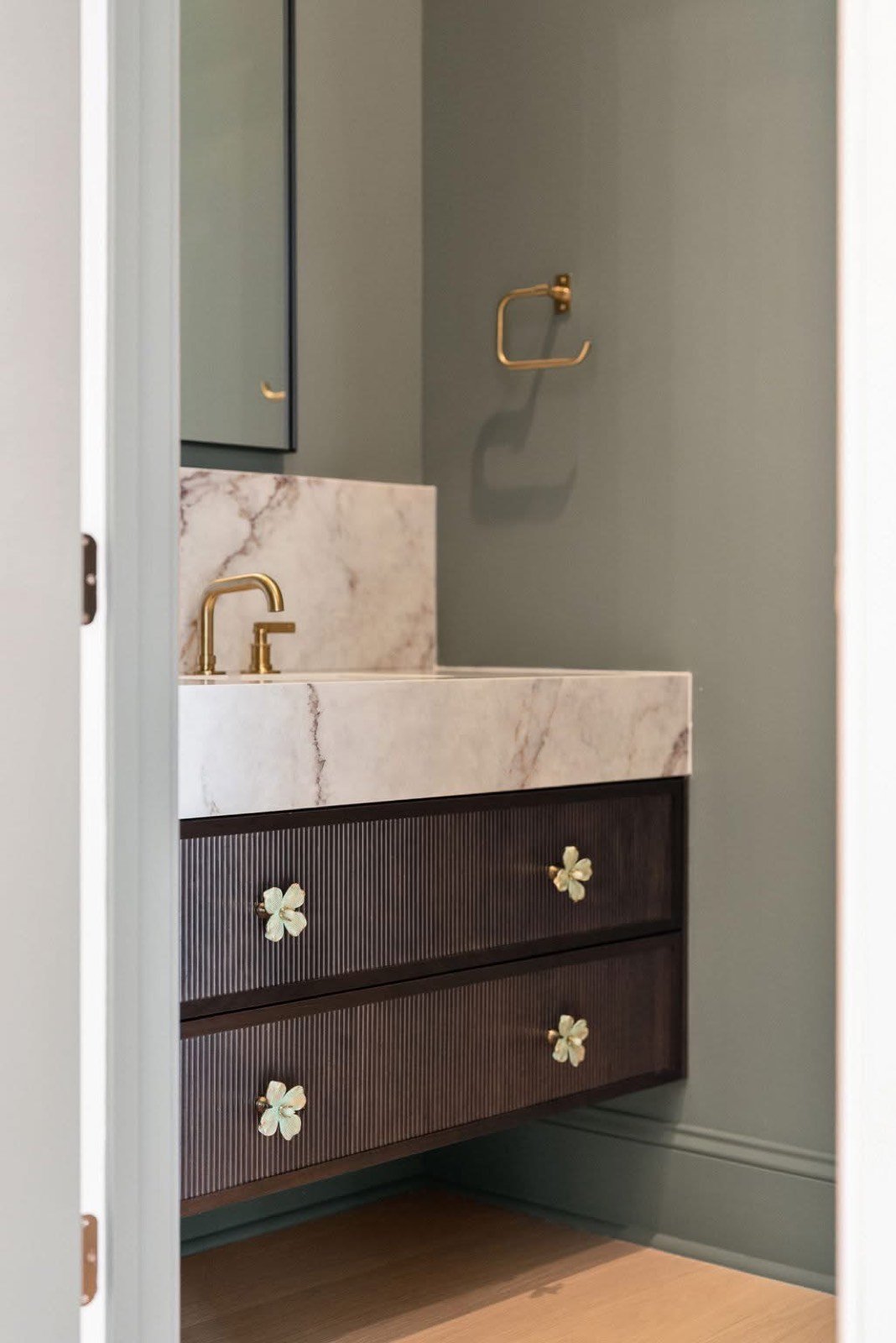 Dark floating vanity with marble top by Coastal Precision CNC