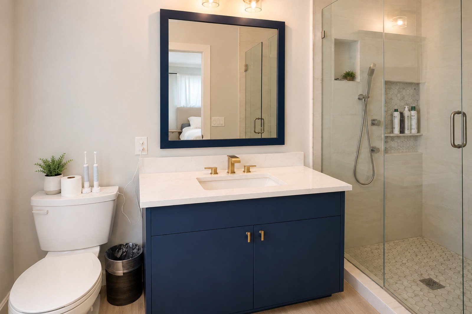 Navy blue vanity with brass fixtures by Coastal Precision CNC