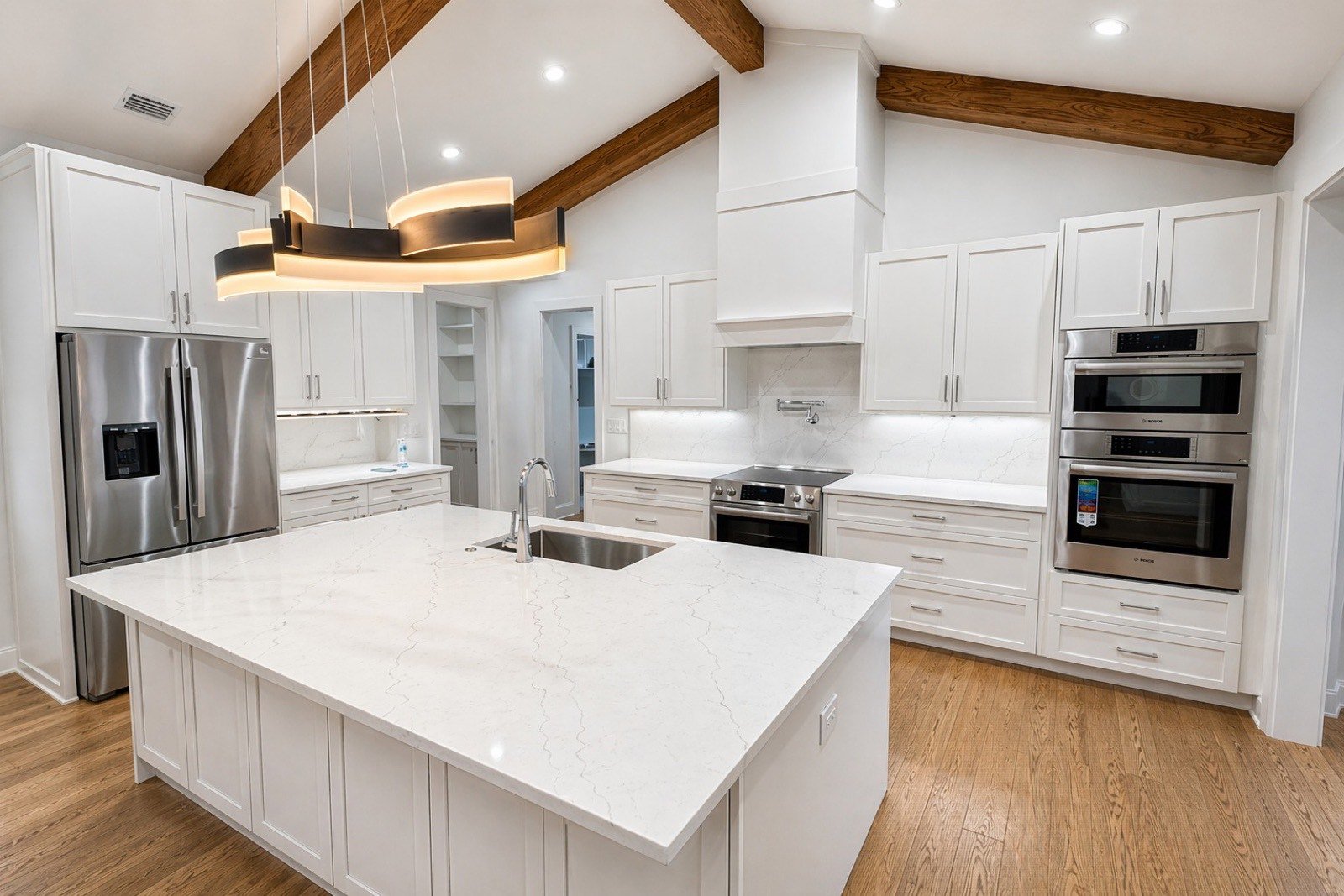 Custom white shaker kitchen with wood beam ceiling by Coastal Precision CNC