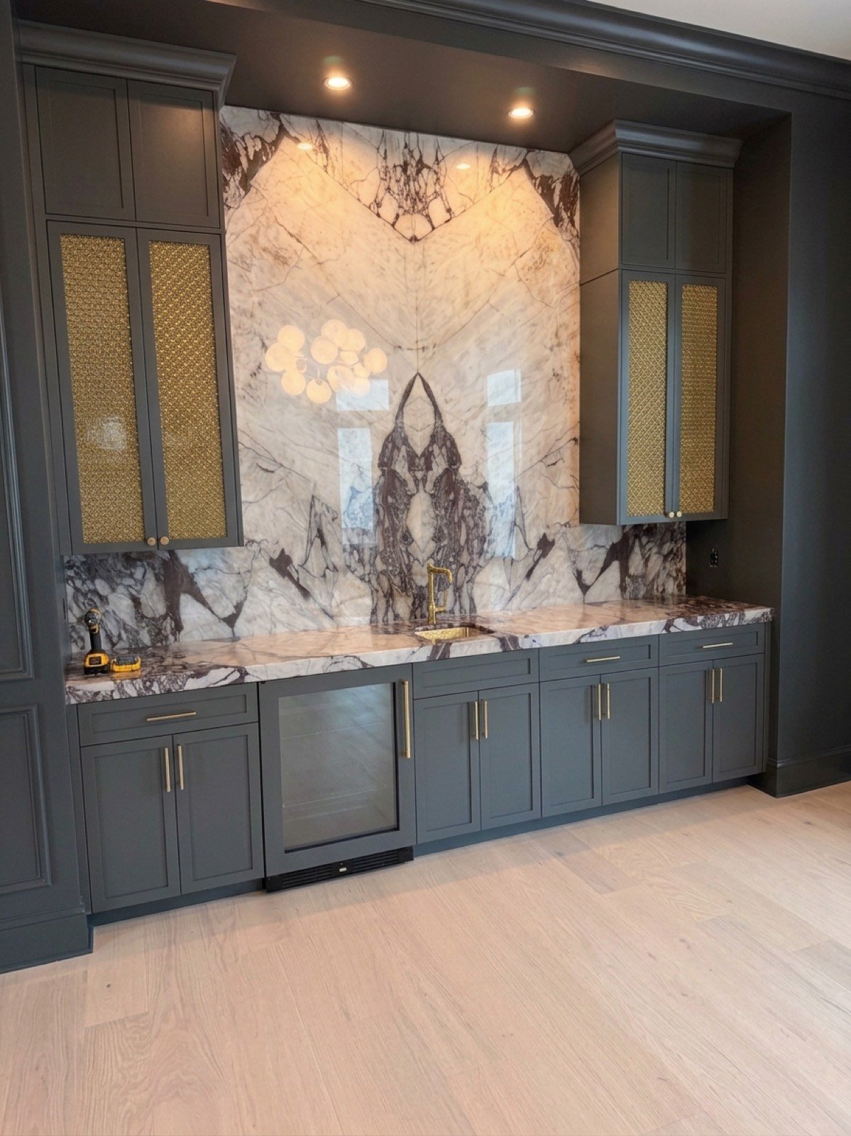 Custom wire mesh cabinet doors with brass hardware by Coastal Precision CNC